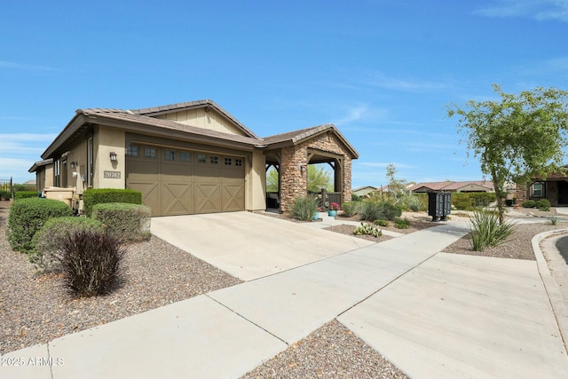 20702 W Hillcrest Blvd, Buckeye, AZ 85396 - view of front facade featuring stucco siding, an attached garage, concrete driveway, a tiled roof, and stone siding