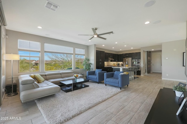 20702 W Hillcrest Blvd, Buckeye, AZ 85396 - living area featuring ceiling fan, wood tiled floors, and recessed lighting