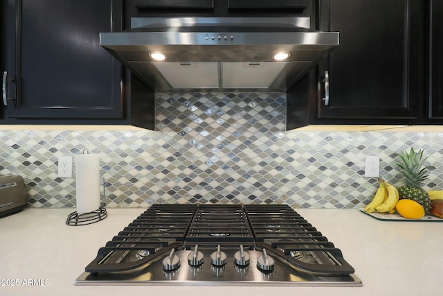 20702 W Hillcrest Blvd, Buckeye, AZ 85396 - kitchen with range hood, stainless steel gas cooktop, light countertops, and backsplash