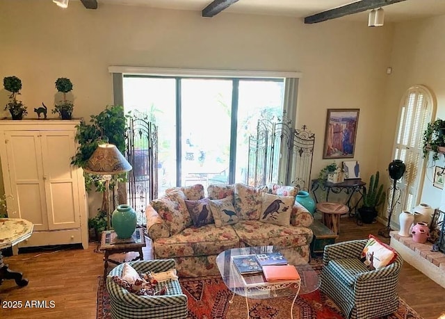 100 N Lazy Fox Rd Unit 8, Wickenburg, AZ 85390 - living area with beamed ceiling, wood finished floors, healthy amount of natural light, and a ceiling fan