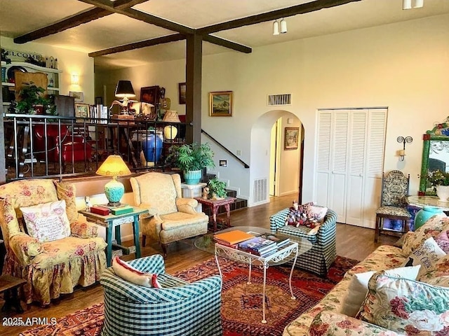 100 N Lazy Fox Rd Unit 8, Wickenburg, AZ 85390 - living room with arched walkways, beamed ceiling, and wood finished floors