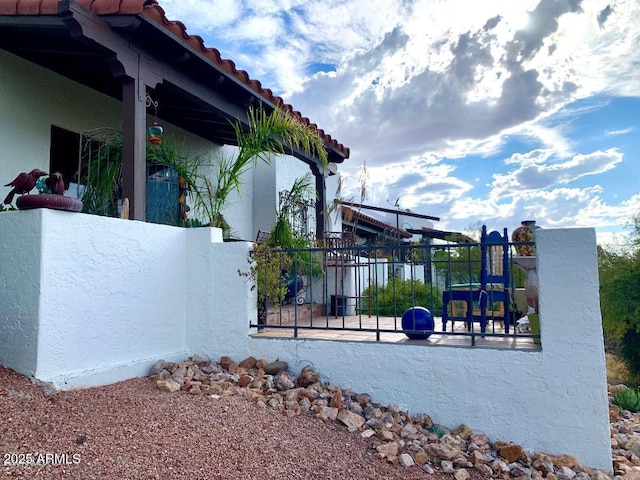 100 N Lazy Fox Rd Unit 8, Wickenburg, AZ 85390 - view of property exterior with stucco siding, a tiled roof, and a playground