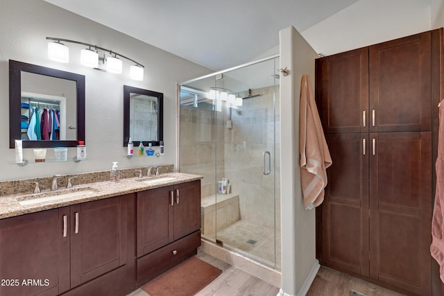 bathroom featuring vanity, hardwood / wood-style flooring, and walk in shower