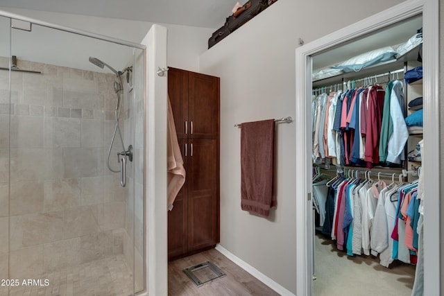 bathroom featuring a shower with door