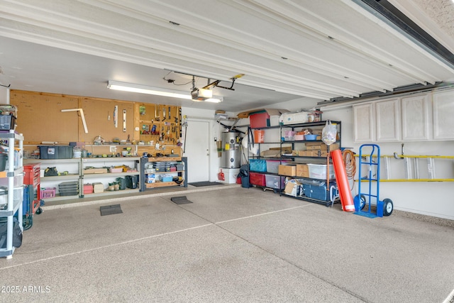 garage featuring water heater, a garage door opener, and a workshop area