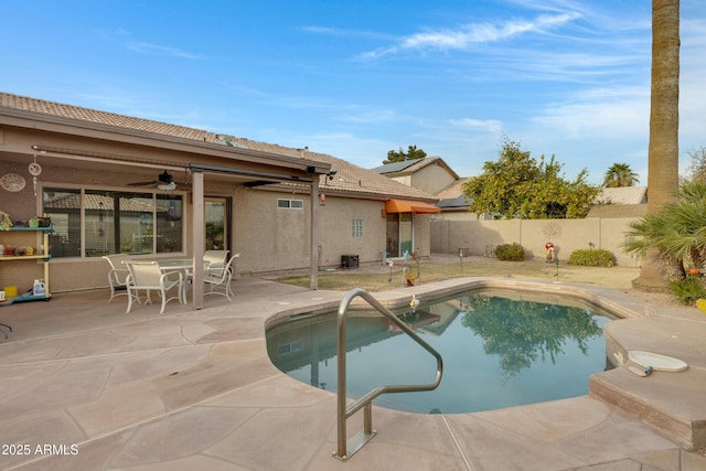 view of swimming pool featuring ceiling fan and a patio area