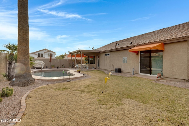 back of property with a fenced in pool, central AC unit, a patio area, and a lawn