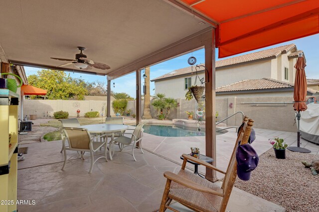 view of patio with a fenced in pool and ceiling fan