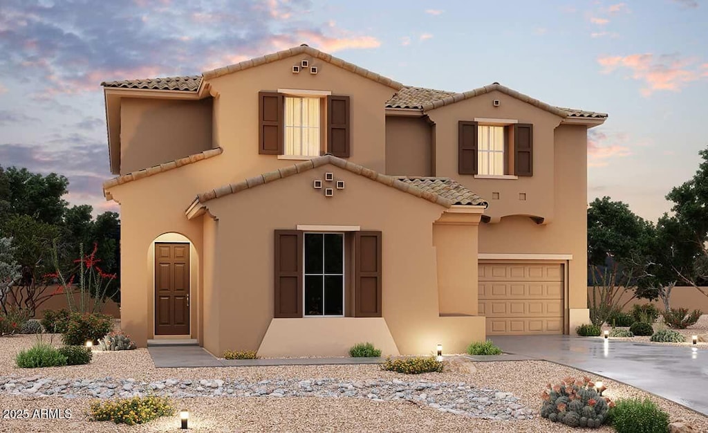 mediterranean / spanish house featuring a garage