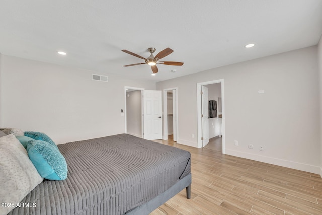 bedroom featuring ceiling fan and ensuite bath