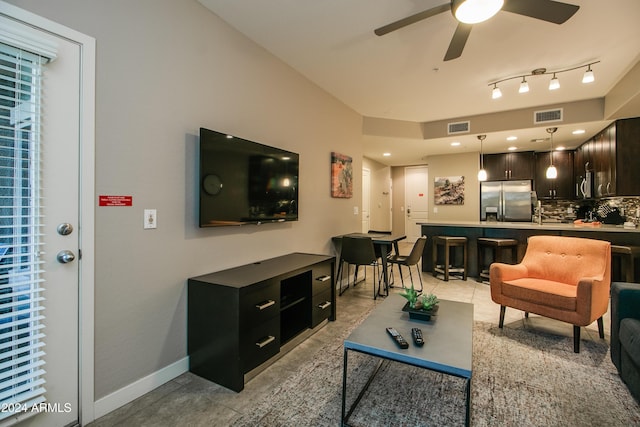 living room with a ceiling fan, baseboards, light tile patterned floors, and visible vents