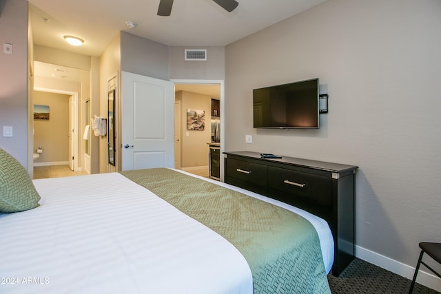 bedroom with baseboards, ceiling fan, ensuite bath, and visible vents