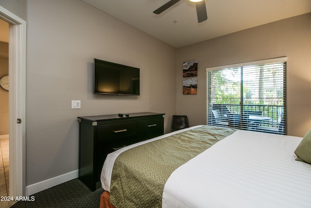 bedroom featuring baseboards and ceiling fan
