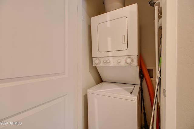 laundry room with stacked washing maching and dryer and laundry area