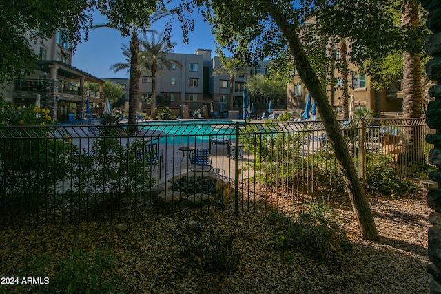 pool featuring a residential view and fence