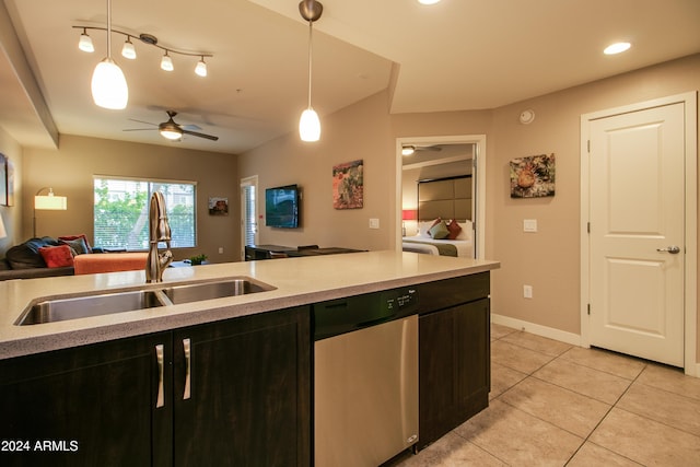 kitchen with a sink, light tile patterned flooring, open floor plan, a ceiling fan, and stainless steel dishwasher
