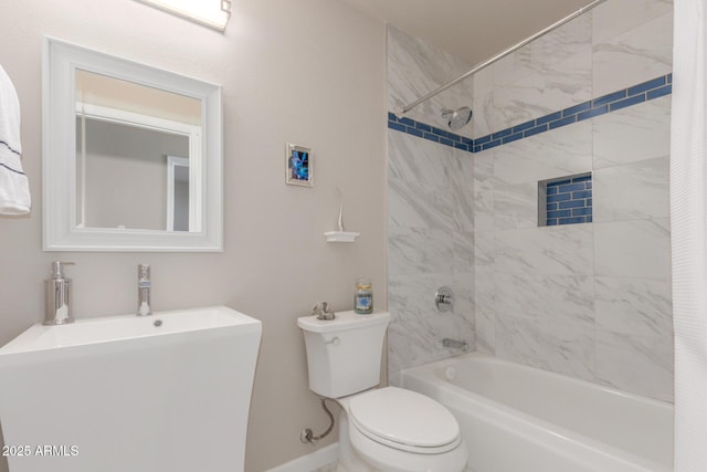 full bath featuring shower / bath combo, a sink, toilet, and baseboards