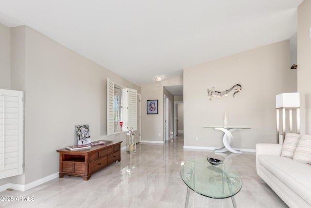 living room with vaulted ceiling, marble finish floor, and baseboards