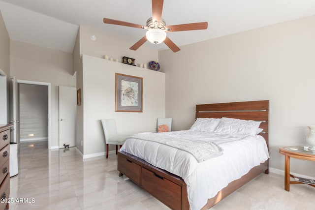 bedroom with vaulted ceiling, ceiling fan, and baseboards