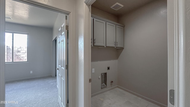 laundry room with light colored carpet, electric dryer hookup, gas dryer hookup, and cabinets