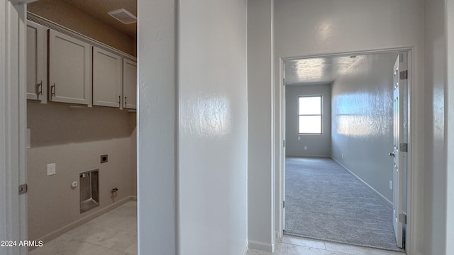 hall featuring light tile patterned flooring