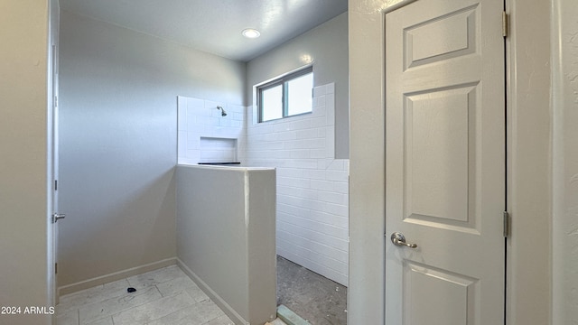 bathroom featuring tile patterned flooring and walk in shower