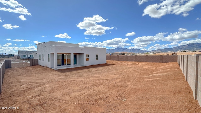 back of property with a mountain view