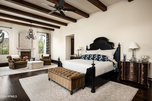 bedroom with beamed ceiling, ceiling fan with notable chandelier, and hardwood / wood-style flooring