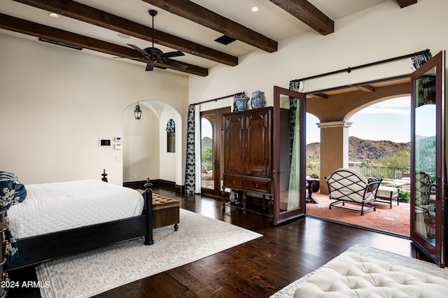 bedroom featuring dark hardwood / wood-style flooring, access to outside, ceiling fan, beam ceiling, and a mountain view