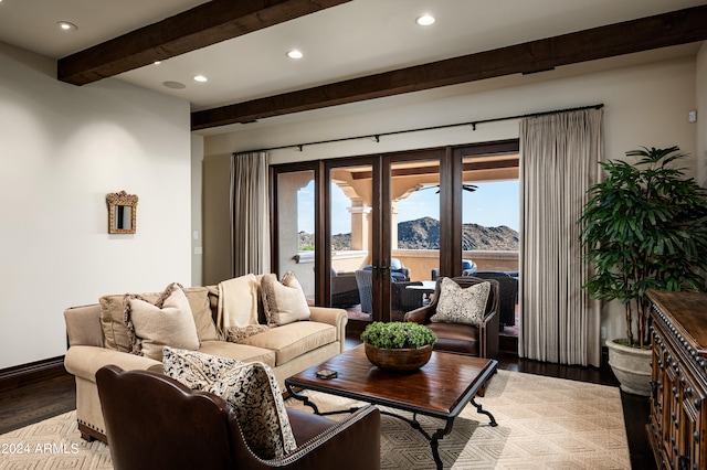 living room with beamed ceiling, a mountain view, french doors, and light hardwood / wood-style flooring