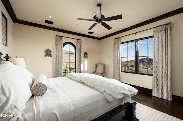 bedroom with ceiling fan, dark hardwood / wood-style flooring, crown molding, and a mountain view