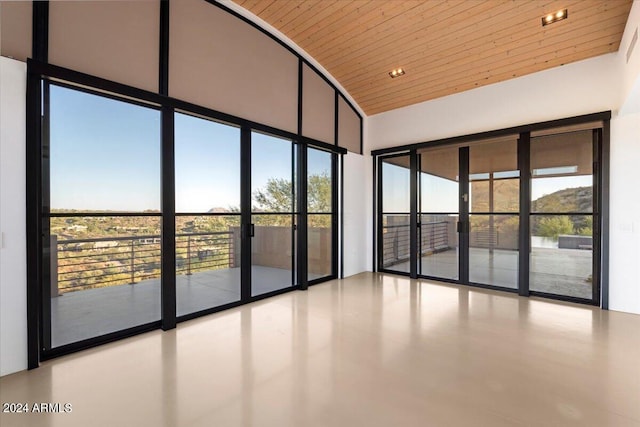 interior space featuring a healthy amount of sunlight, a high ceiling, and wood ceiling