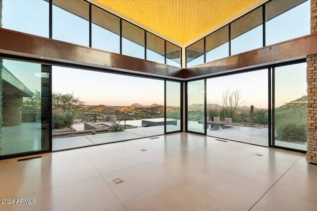 interior space with a high ceiling and wooden ceiling