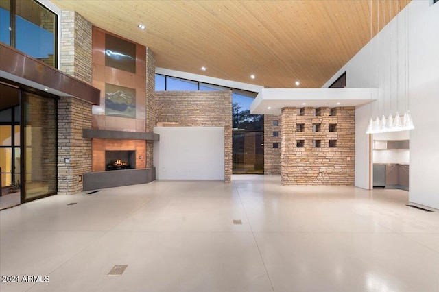 unfurnished living room with a fireplace, wood ceiling, and high vaulted ceiling