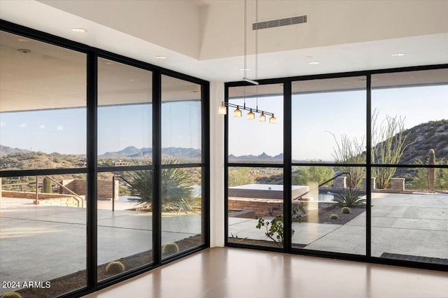 doorway to outside with floor to ceiling windows and a mountain view