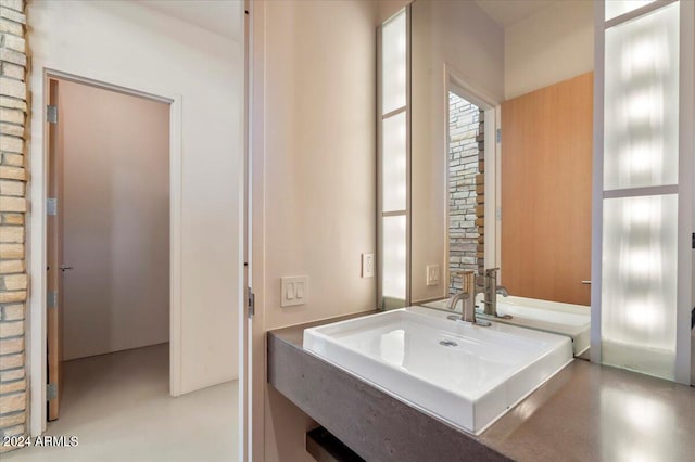 bathroom with concrete flooring and sink