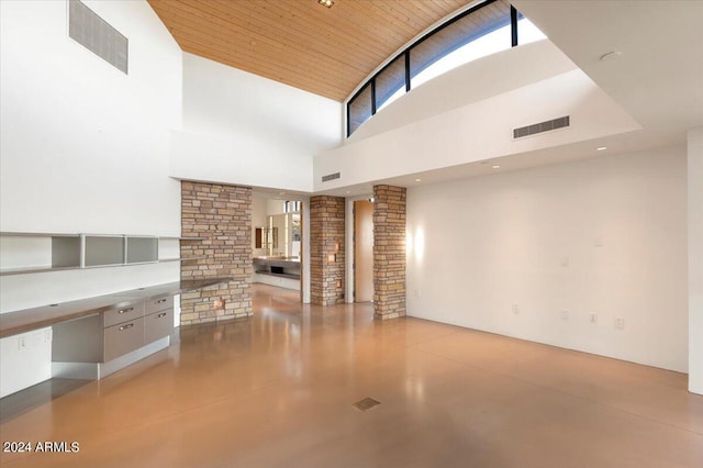 unfurnished living room featuring high vaulted ceiling, decorative columns, and wooden ceiling