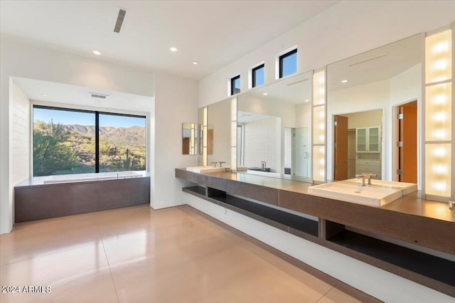 bathroom with a mountain view, vanity, and a washtub