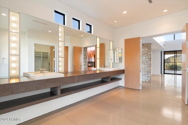 interior space featuring a stone fireplace and sink