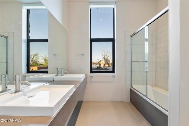 bathroom featuring bath / shower combo with glass door, vanity, and tile patterned floors