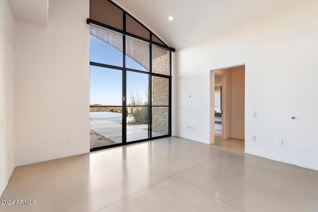 spare room with high vaulted ceiling