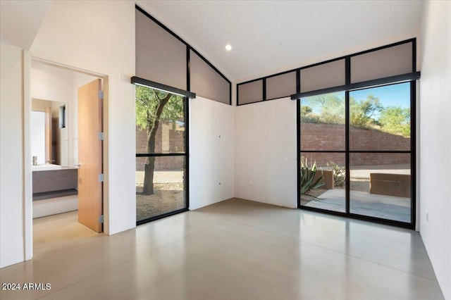 unfurnished room featuring a towering ceiling