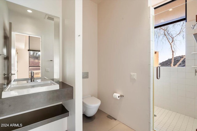 bathroom featuring tile patterned flooring, vanity, toilet, and a shower with shower door