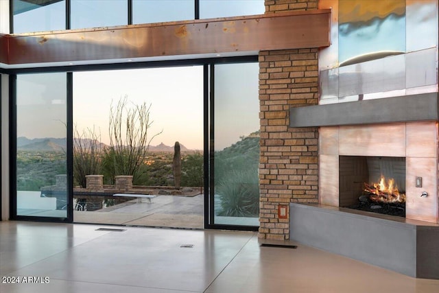 entryway with a fireplace and a wall of windows