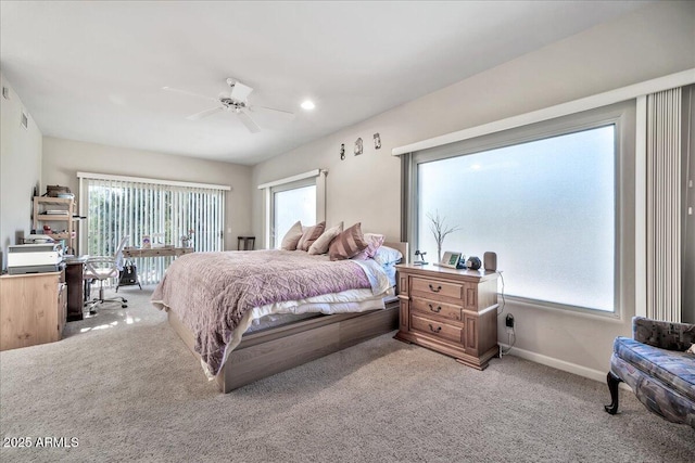 bedroom featuring ceiling fan, carpet, and multiple windows