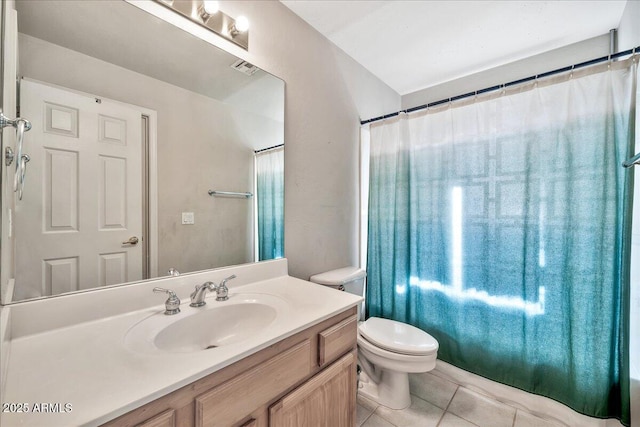 bathroom featuring toilet, tile patterned floors, and vanity