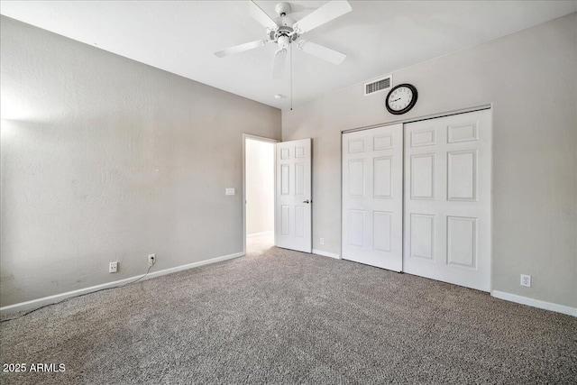 unfurnished bedroom with ceiling fan, a closet, and carpet