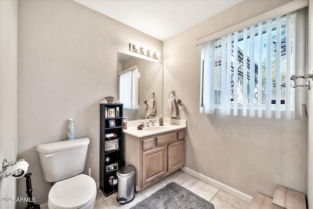 bathroom featuring tile patterned floors, vanity, and toilet