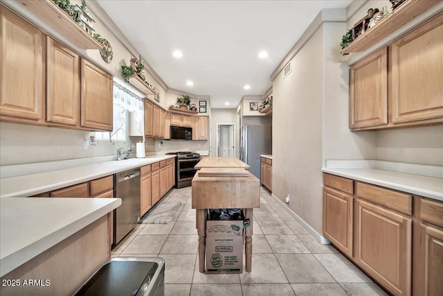 kitchen featuring a kitchen island, sink, stainless steel appliances, light tile patterned floors, and butcher block counters