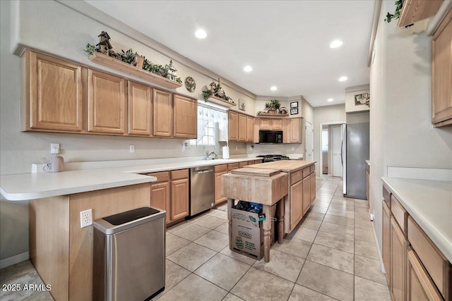 kitchen with dishwasher, butcher block countertops, stove, sink, and light tile patterned flooring